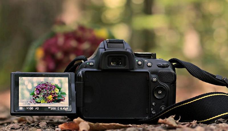A camera with some flowers in the focus screen