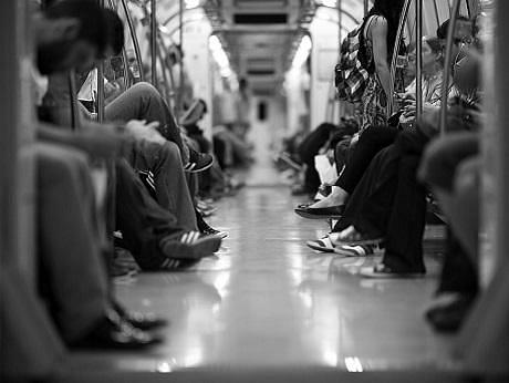 People sitting on a busy tube train