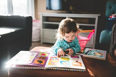 A young child reading a picture book