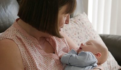 Woman cradling a baby