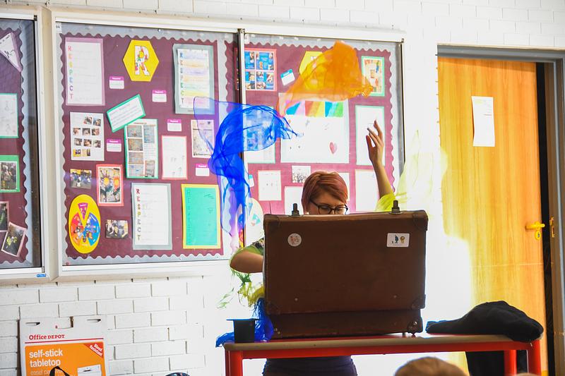 Woman throwing scarves in classroom