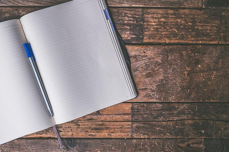 A notebook and pen on a table