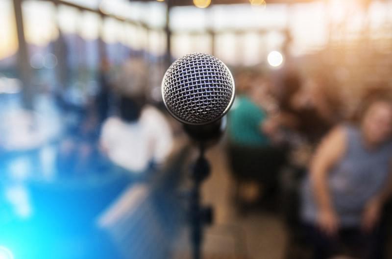 A microphone in focus with a crowd in the background