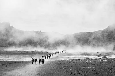 Figures walking away over a desert landscape