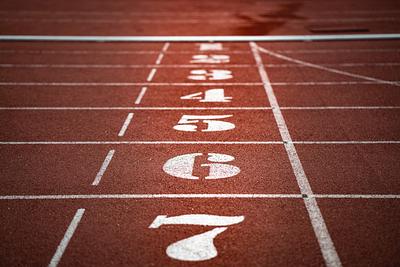 numbers on starting line of red rubber running track