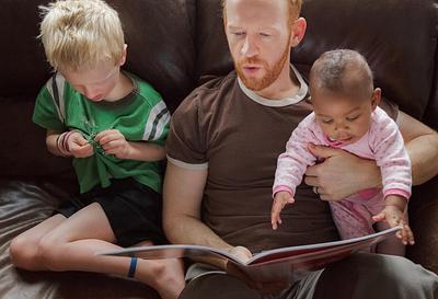 Father and children reading together