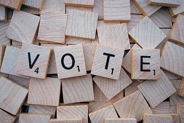 Scrabble pieces spelling out the word 'Vote'
