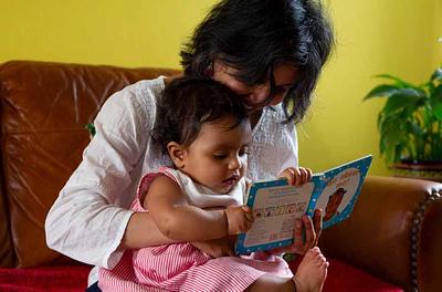 Mum reading a book with child