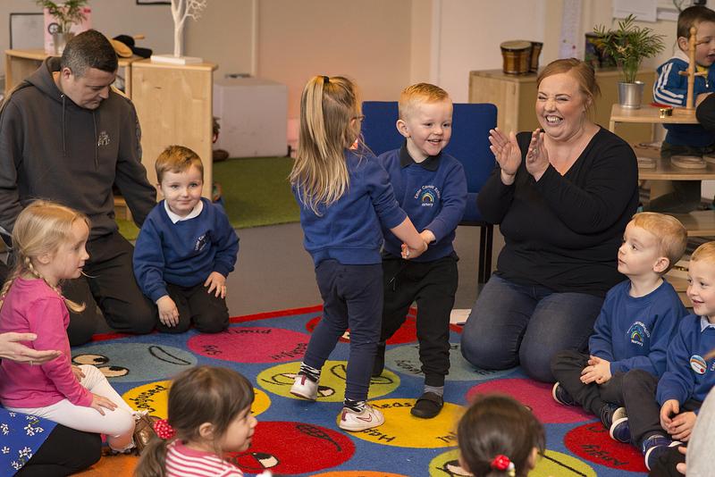 Children and parents dancing and signing at nursery Bookbug Session