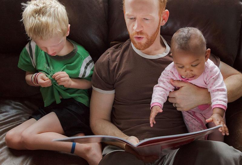 Decorative image - dad reading with two children