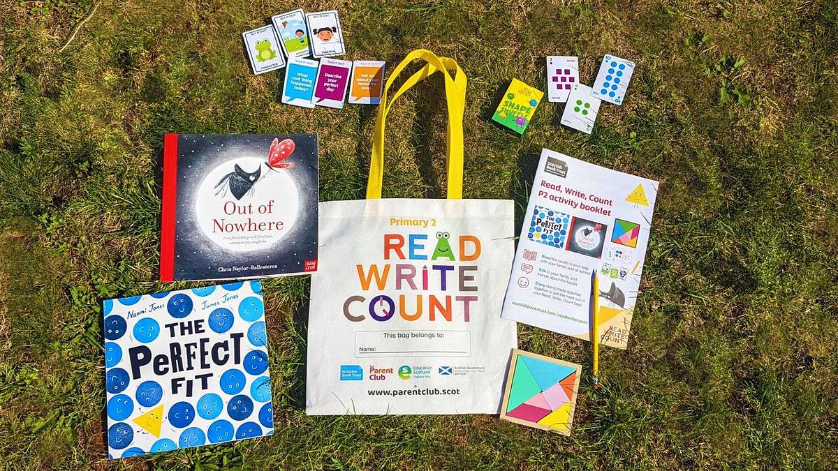 Read Write Count P2 Bag surrounded by books and stationery on grassy field