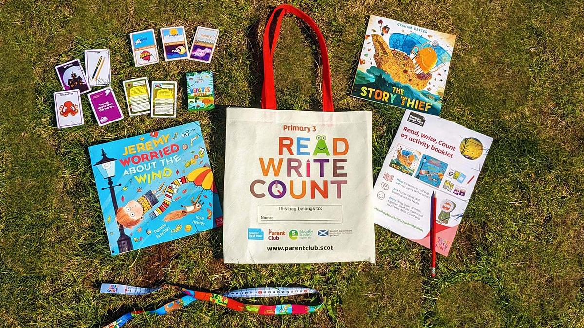 Read Write Count P3 Bag surrounded by books and stationery on grassy field