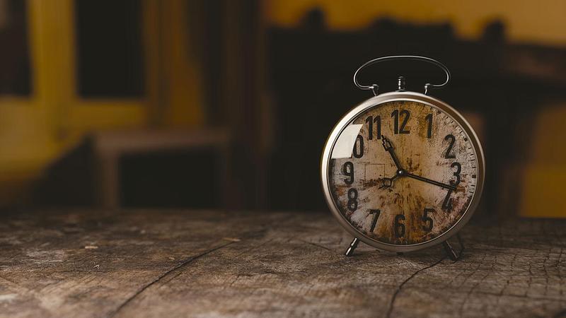 A rustic alarm clock on a table