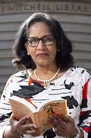 Author picture of Leela Soma holding an open book Author picture of Leela Soma holding an open book
