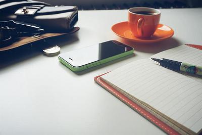 Notebook, coffee and smartphone on a table