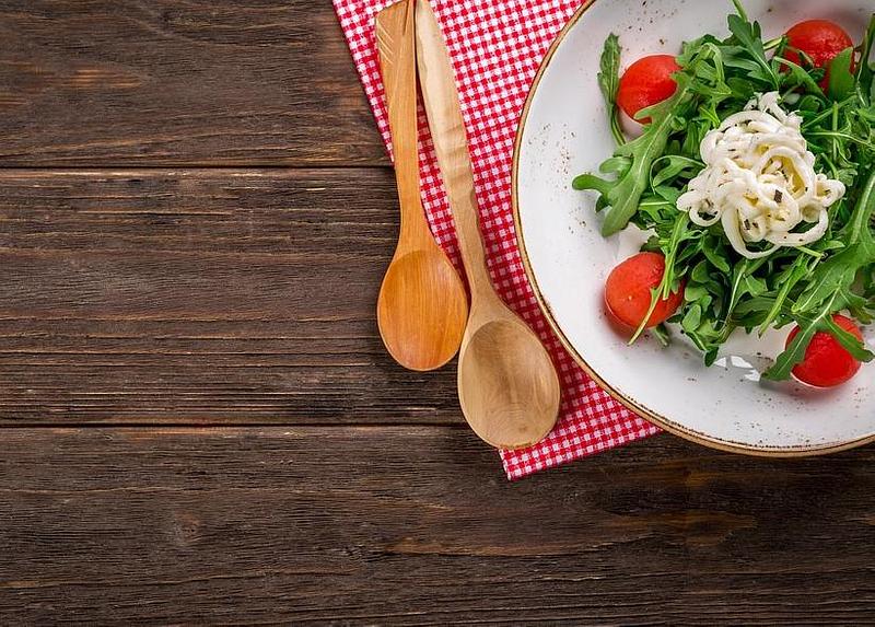 Salad in a bowl with salad servers